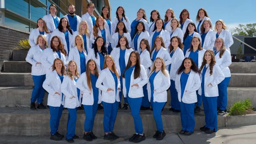 Nursing students at the Health Science Center. All pictures are wearing scrubs and white coats.